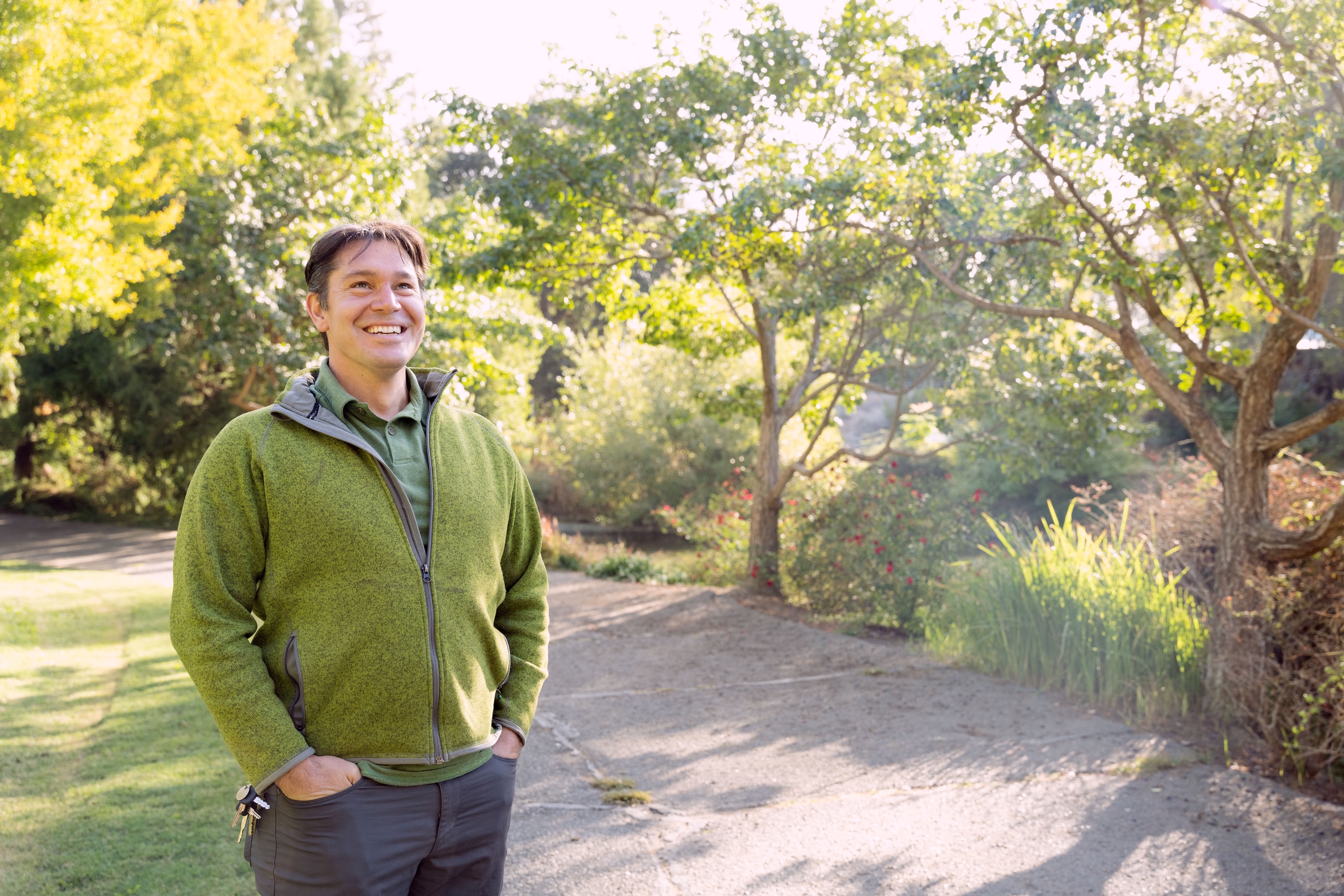 Tyler Kern smiles, posing outside near Lake Spafford