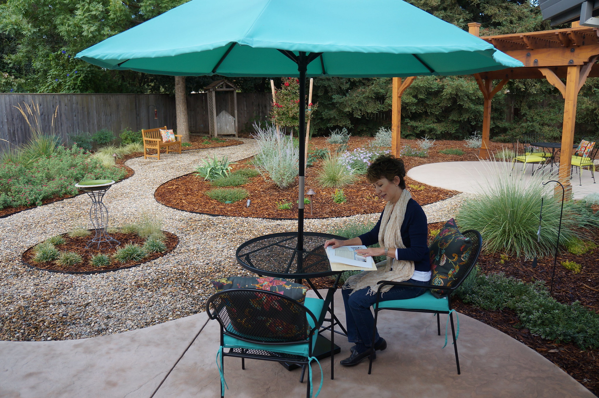Image of Ria diGrassi reading outside in her backyard.